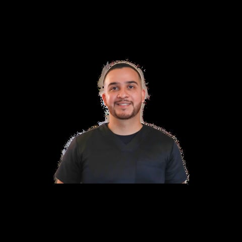 Portrait of a man with a beard wearing a black t-shirt against a black background