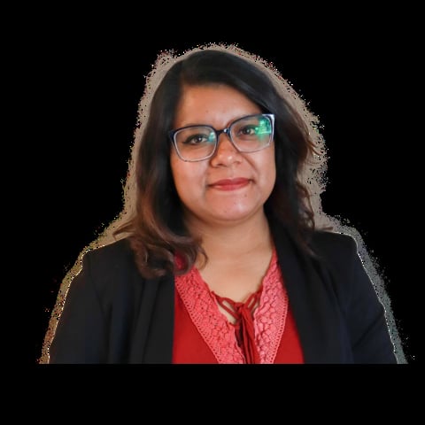 Professional headshot of a woman with dark shoulder-length hair, wearing glasses, red patterned blouse, and black blazer against a black background