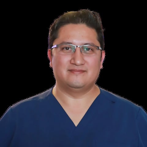 Portrait of a man wearing glasses and a dark blue v-neck shirt against a black background