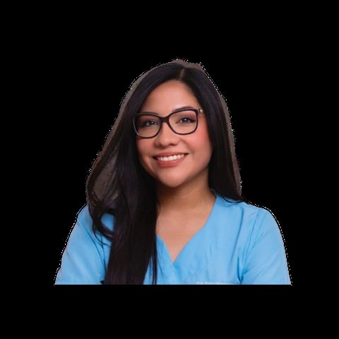 Woman with long dark hair and glasses wearing a blue v-neck top, smiling at the camera against a black background