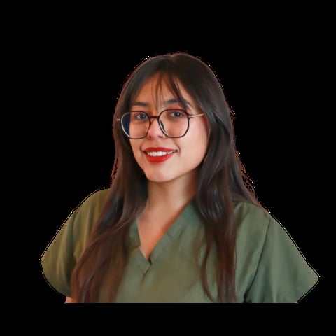 Woman with long dark hair, glasses, and red lipstick wearing an olive green shirt against a black background
