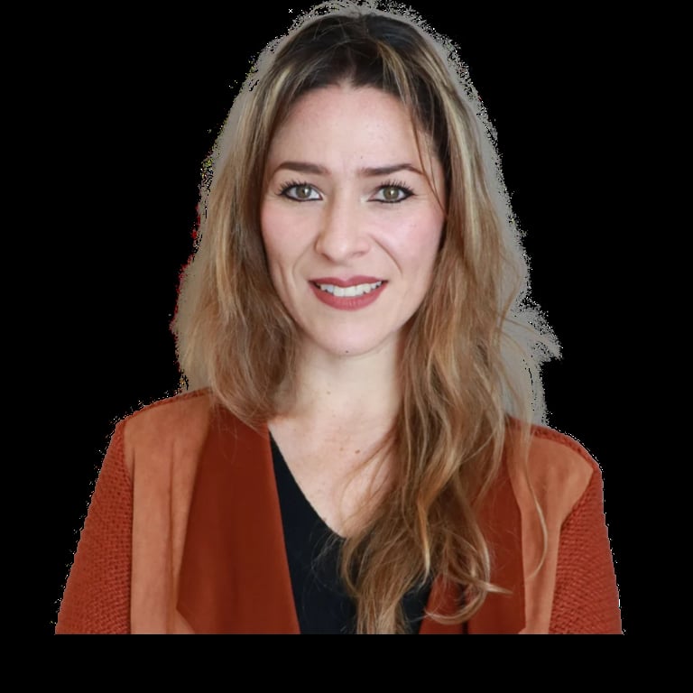 Woman with shoulder-length brown hair wearing a rust-colored cardigan over a black top, smiling at the camera against a black background