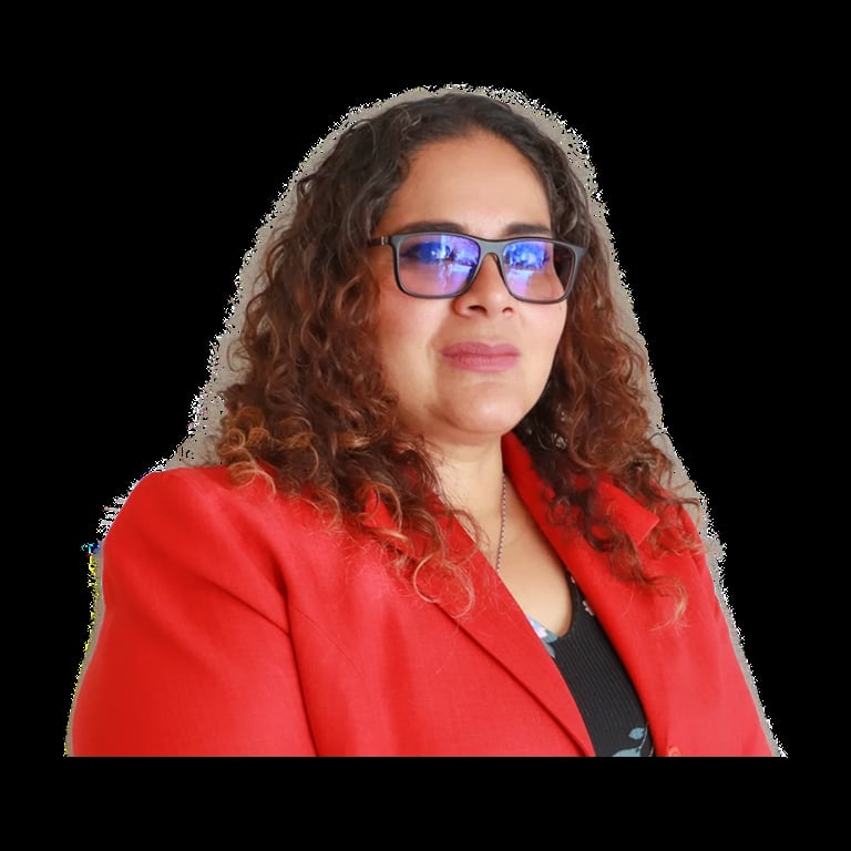 Woman with long curly reddish-brown hair wearing blue-tinted glasses and a bright red blazer over a black top