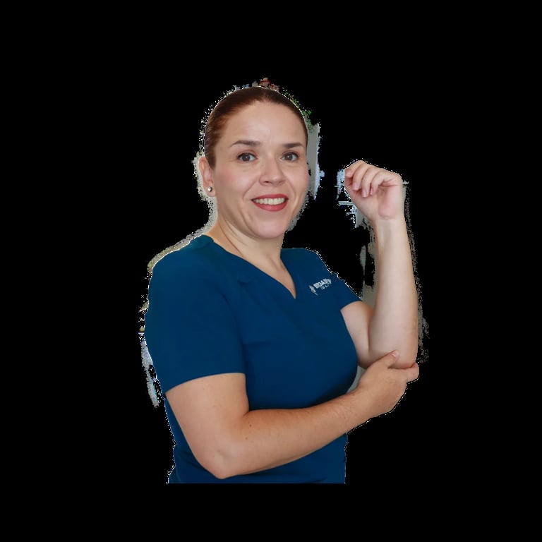 Woman in dark blue medical scrubs smiling at camera with arm flexed, isolated on black background
