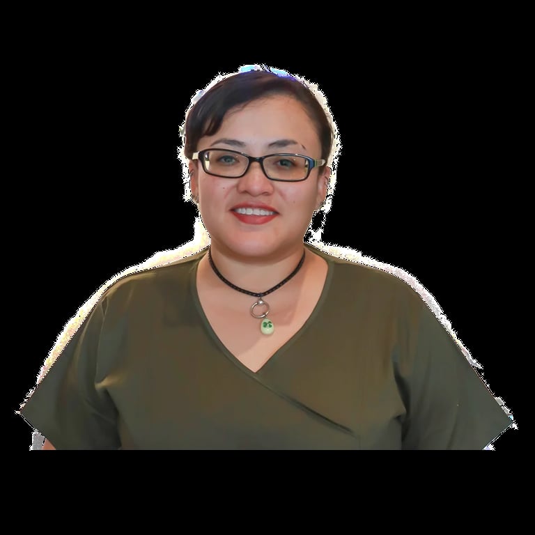 Portrait of a smiling woman wearing glasses, a green top, and a pendant necklace against a transparent background
