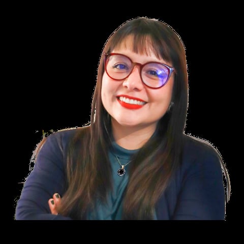 Young woman with long dark hair, glasses, and red lipstick smiling at camera wearing a dark blue top