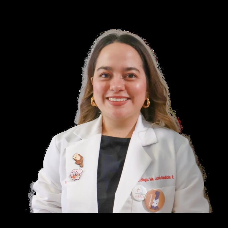 Professional headshot of a woman wearing a white medical coat over a black shirt, smiling at the camera against a black background.